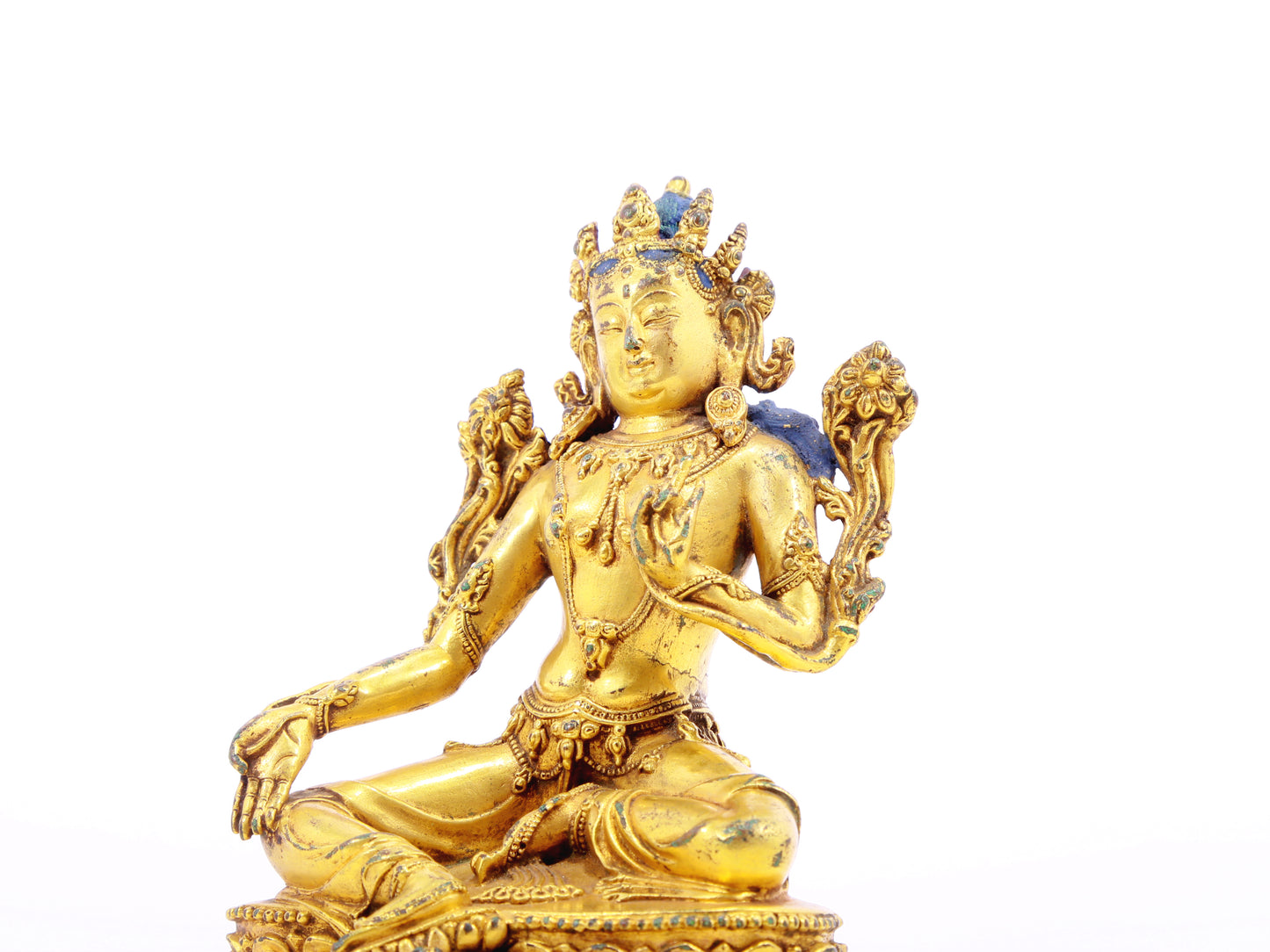 A serene gilt bronze statue of green Tara