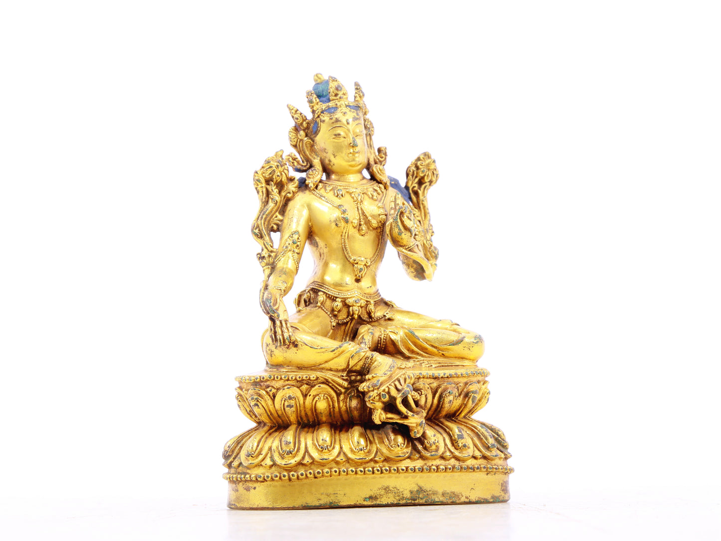 A serene gilt bronze statue of green Tara