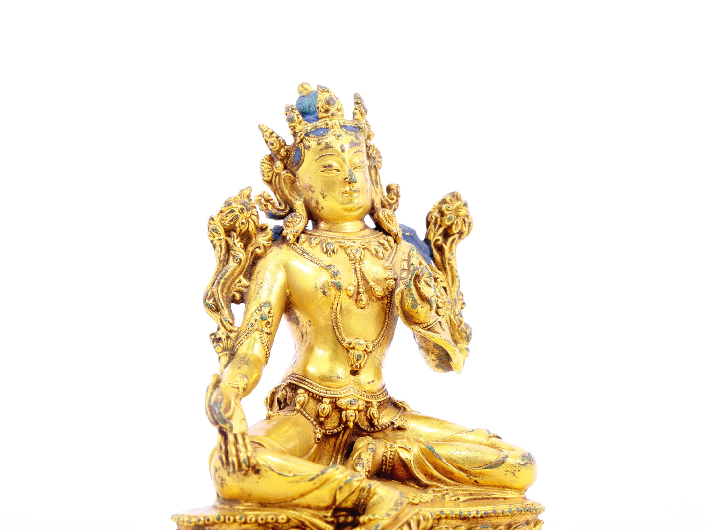 A serene gilt bronze statue of green Tara