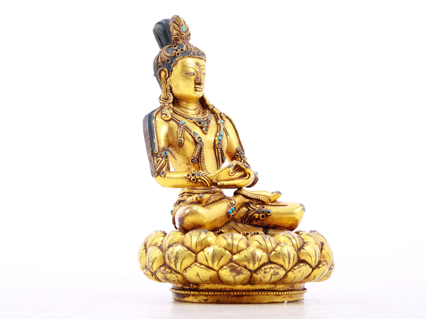 A serene gilt bronze statue of Bodhisattva inlaid with turquoise