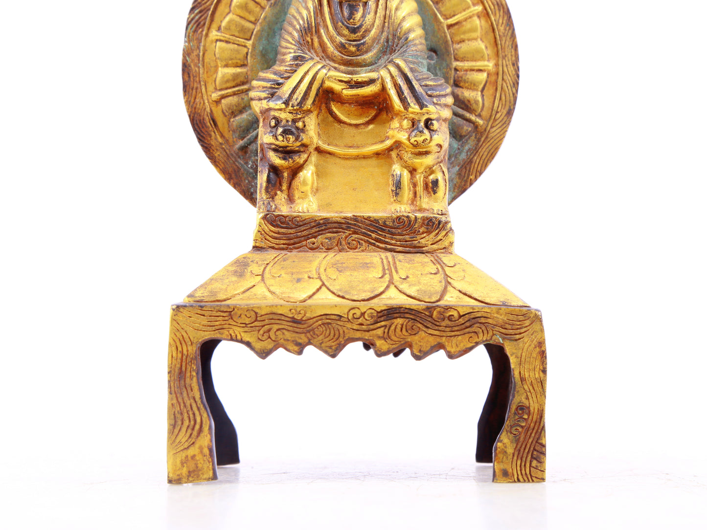 A serene gilt bronze statue of Gautama Buddha