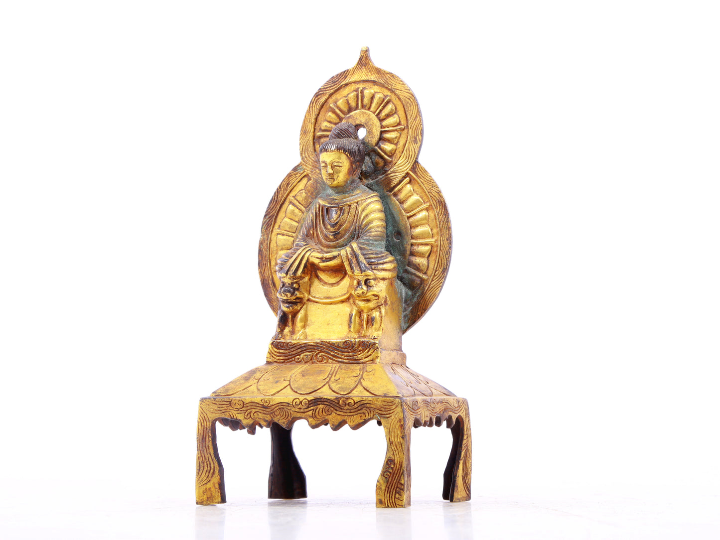 A serene gilt bronze statue of Gautama Buddha