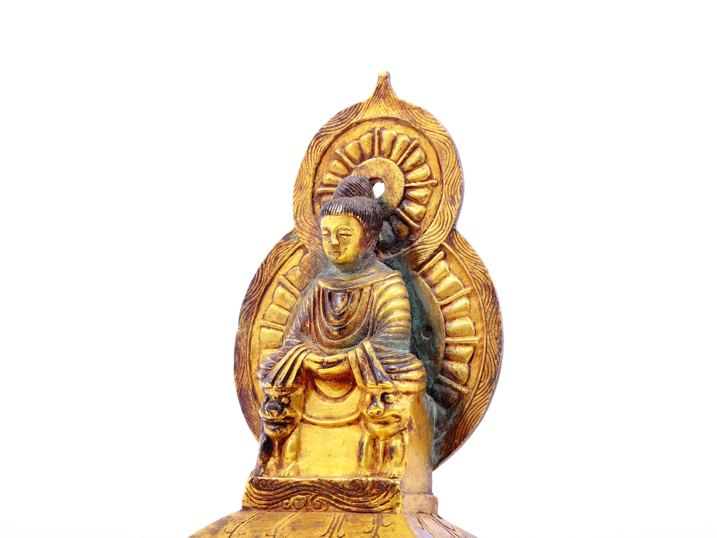 A serene gilt bronze statue of Gautama Buddha