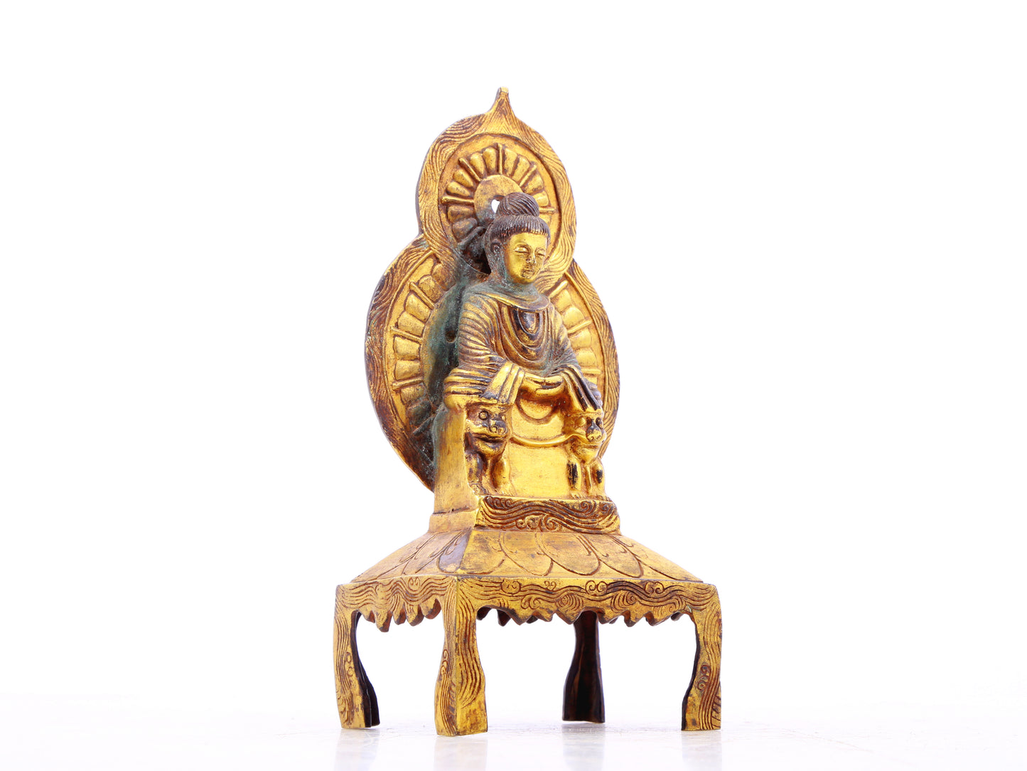 A serene gilt bronze statue of Gautama Buddha