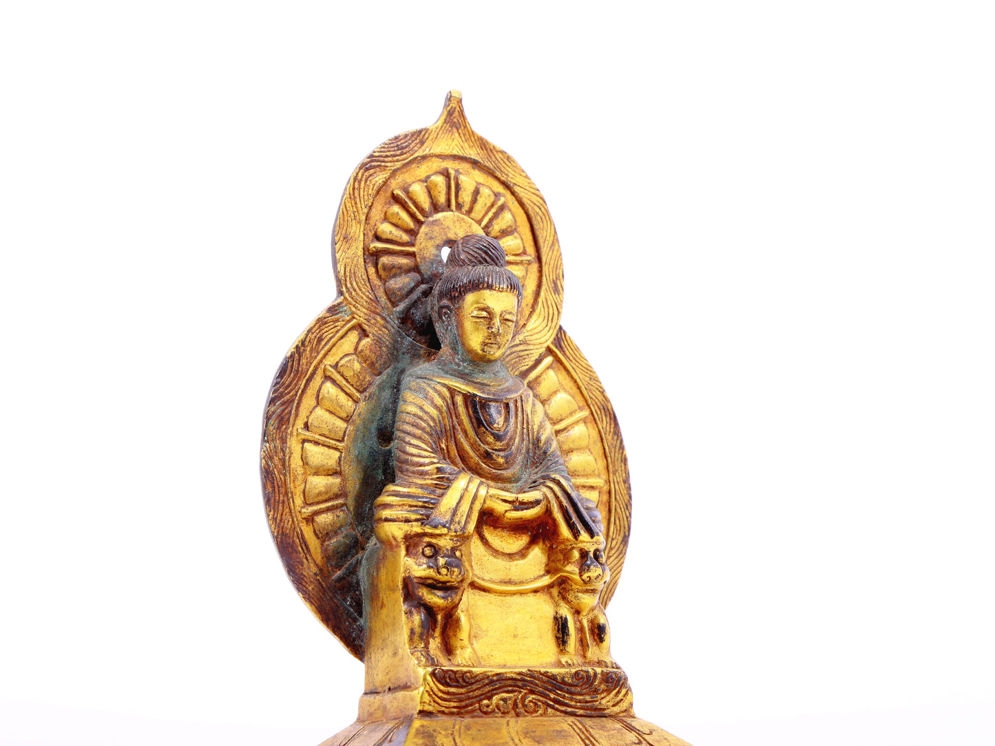 A serene gilt bronze statue of Gautama Buddha