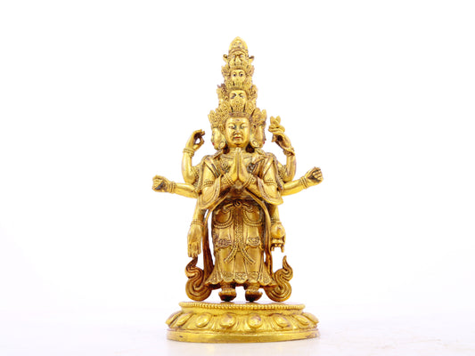 A serene gilt bronze statue of Guanyin with eleven faces