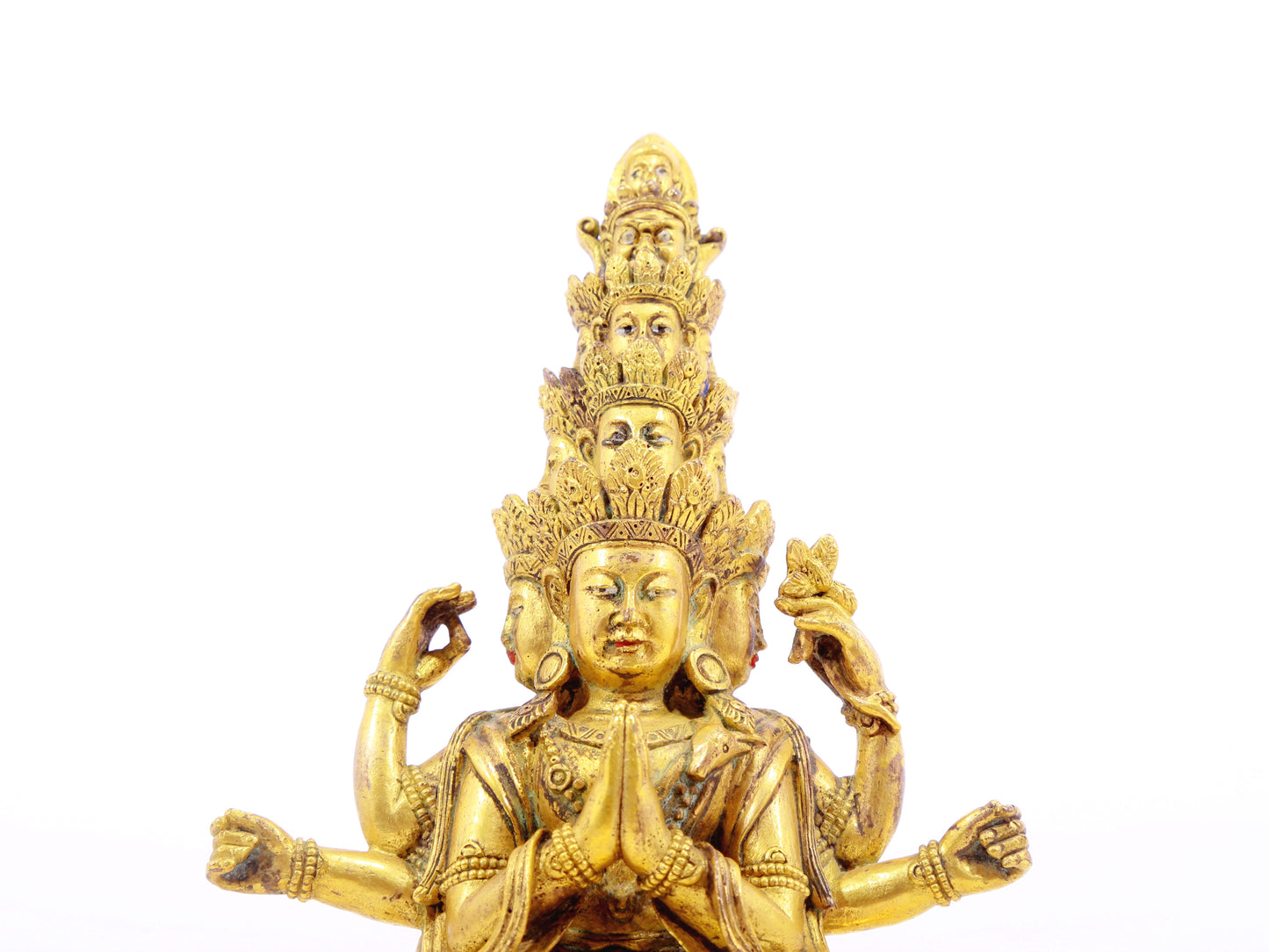 A serene gilt bronze statue of Guanyin with eleven faces