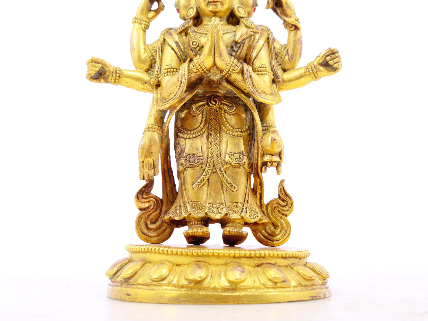 A serene gilt bronze statue of Guanyin with eleven faces