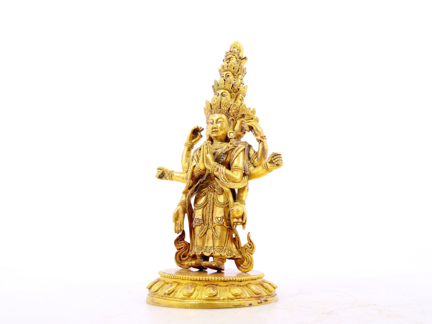 A serene gilt bronze statue of Guanyin with eleven faces