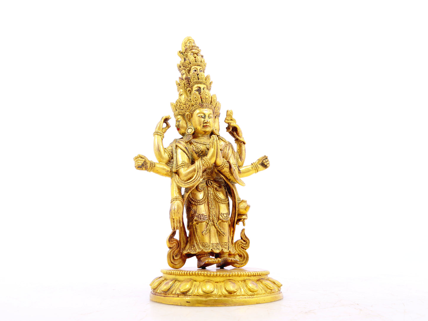 A serene gilt bronze statue of Guanyin with eleven faces