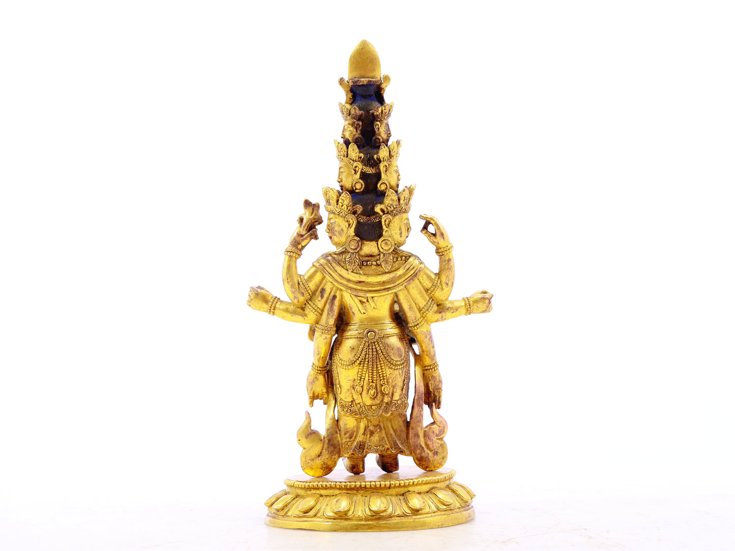 A serene gilt bronze statue of Guanyin with eleven faces