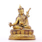 A serene gilt bronze statue of Padmasambhava