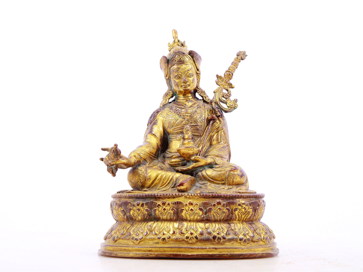 A serene gilt bronze statue of Padmasambhava