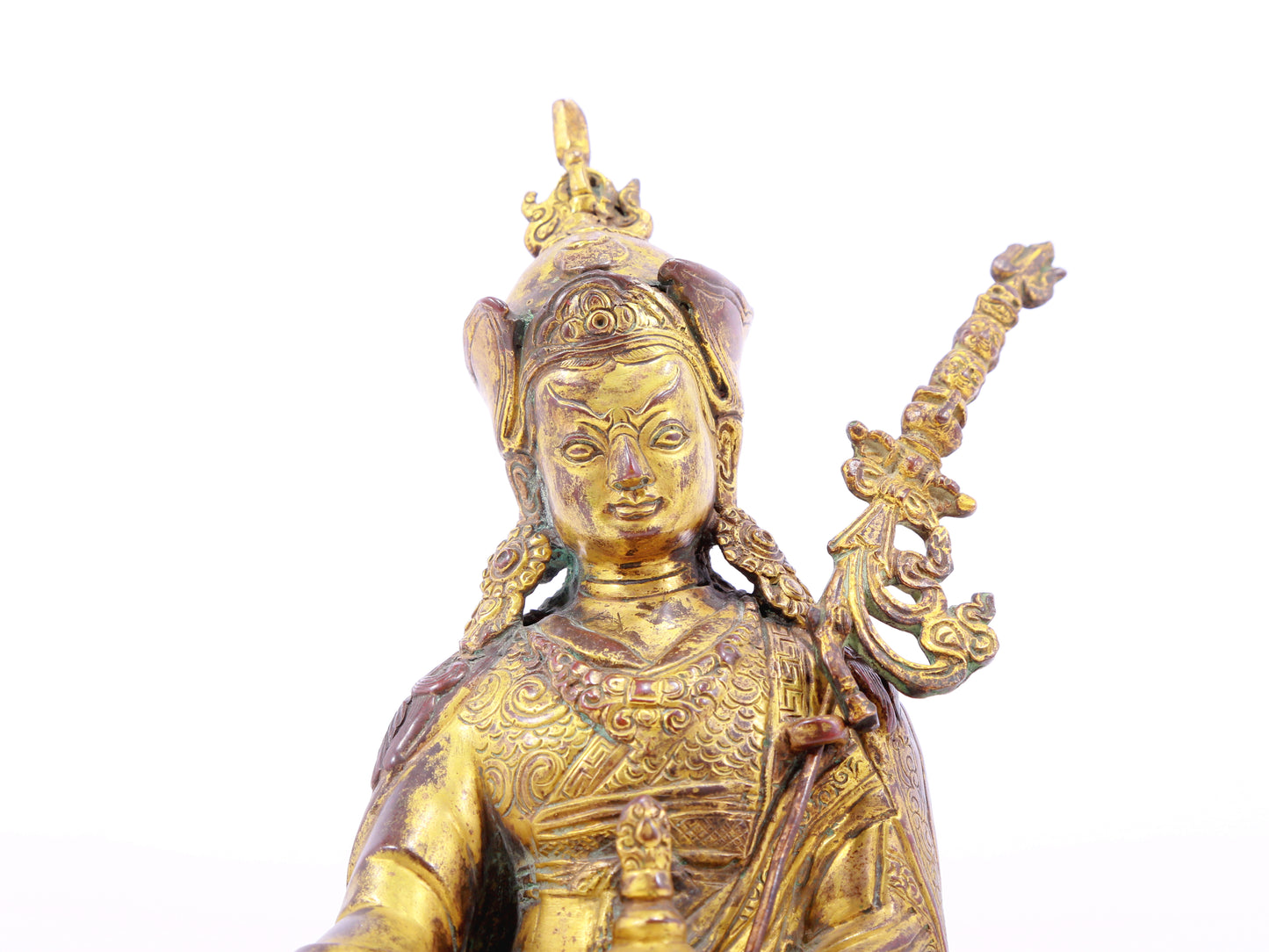 A serene gilt bronze statue of Padmasambhava