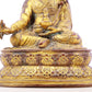 A serene gilt bronze statue of Padmasambhava