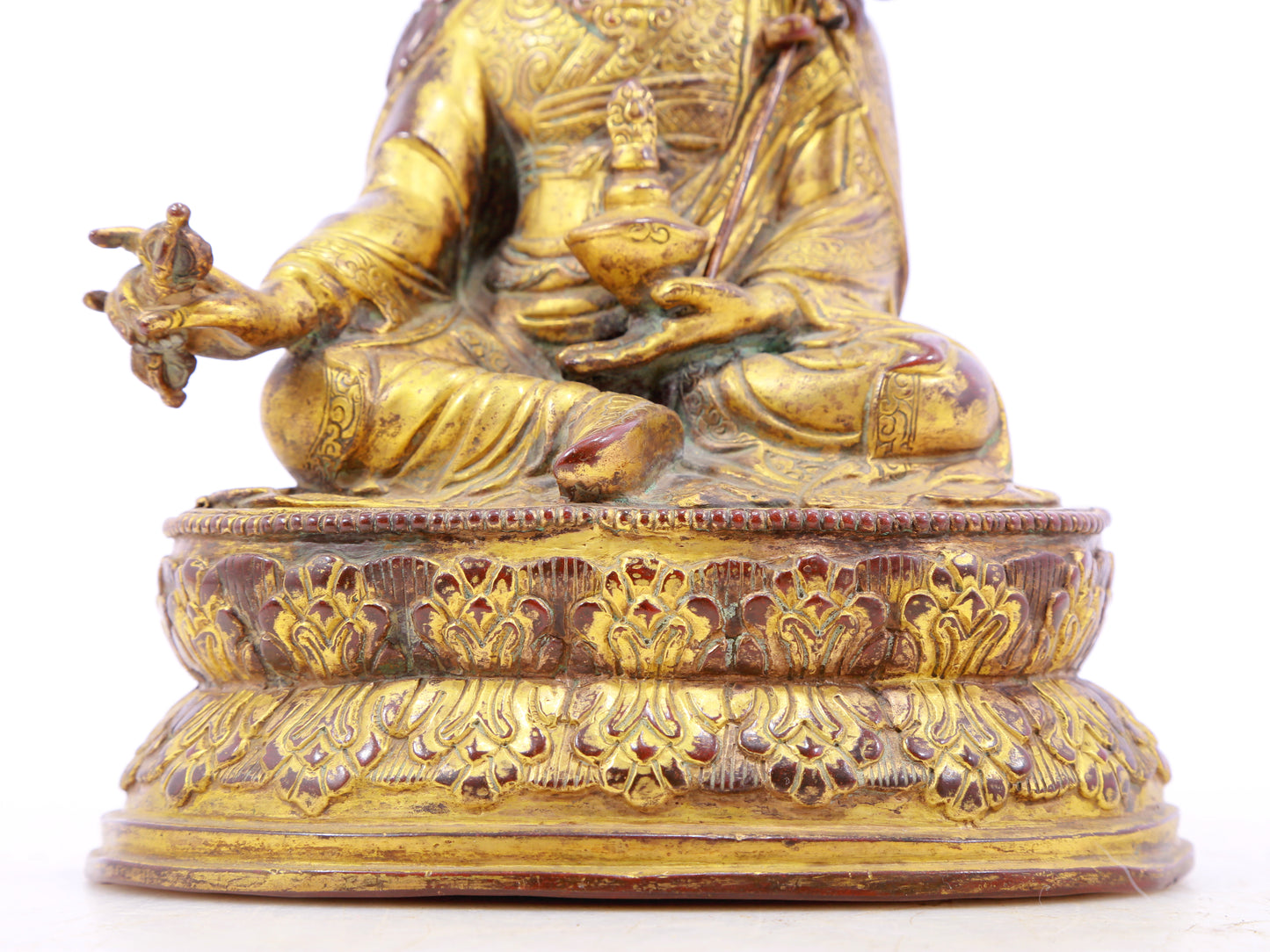 A serene gilt bronze statue of Padmasambhava