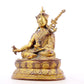 A serene gilt bronze statue of Padmasambhava