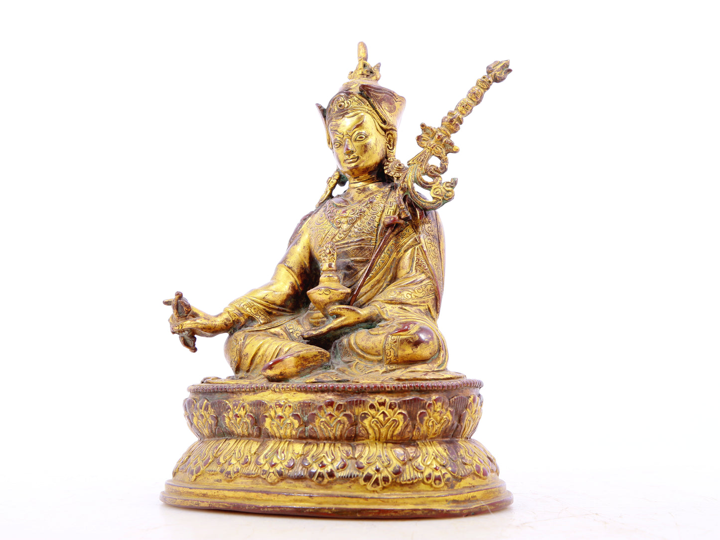 A serene gilt bronze statue of Padmasambhava