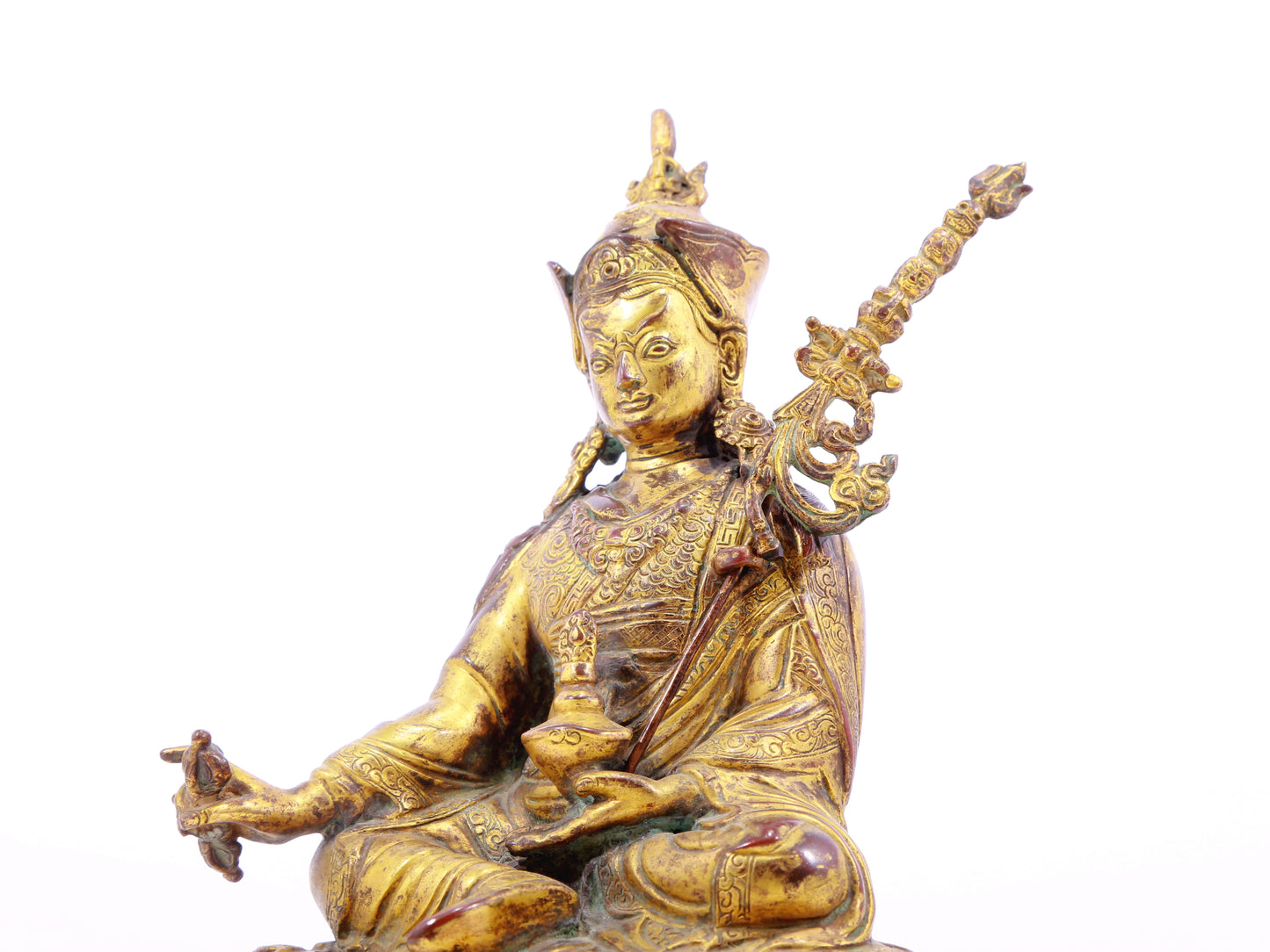 A serene gilt bronze statue of Padmasambhava