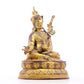 A serene gilt bronze statue of Padmasambhava