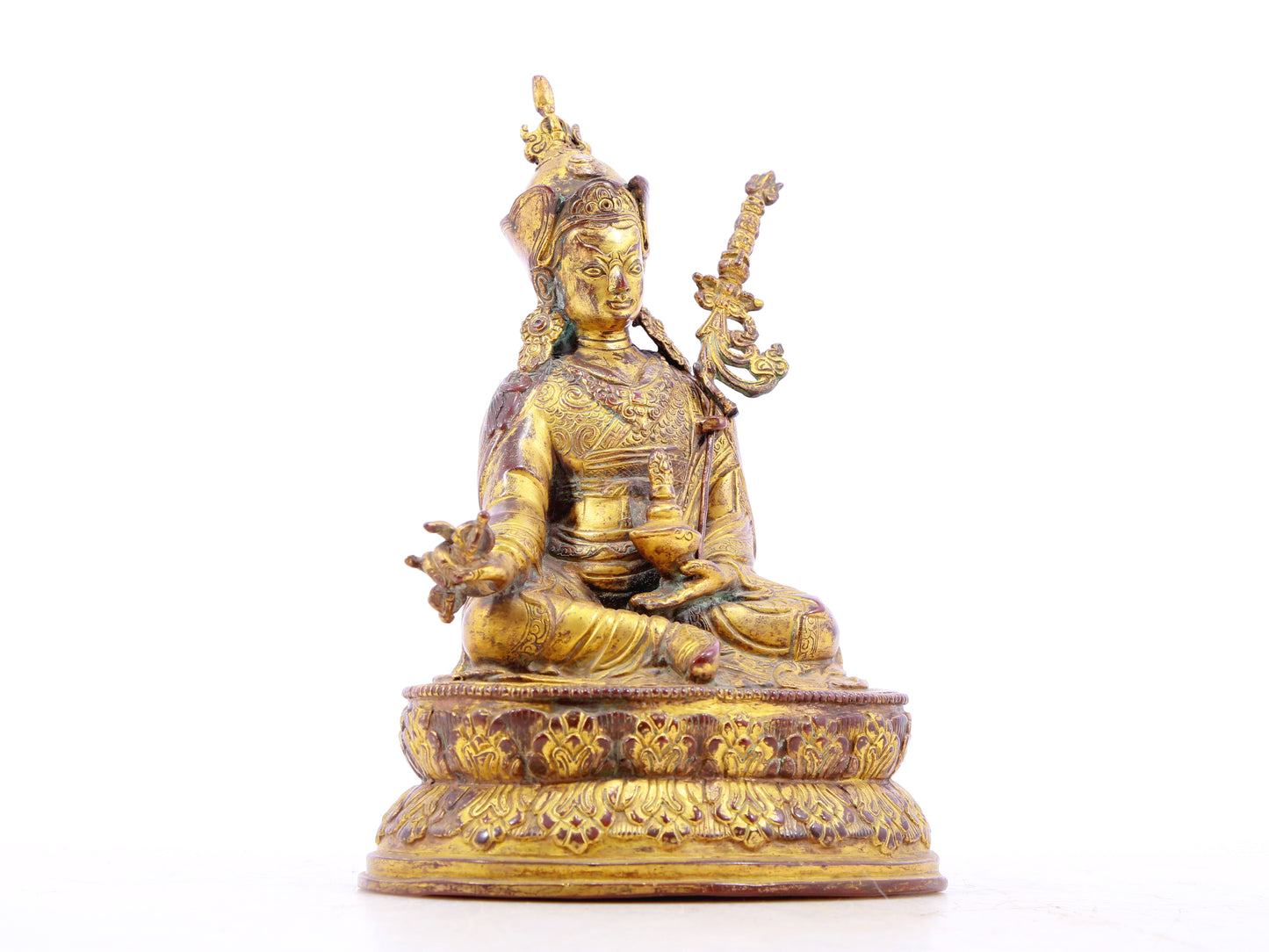 A serene gilt bronze statue of Padmasambhava