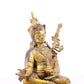 A serene gilt bronze statue of Padmasambhava