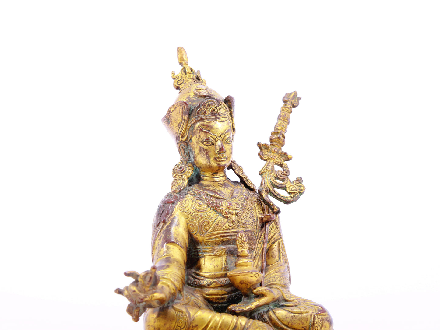 A serene gilt bronze statue of Padmasambhava