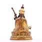 A serene gilt bronze statue of Padmasambhava