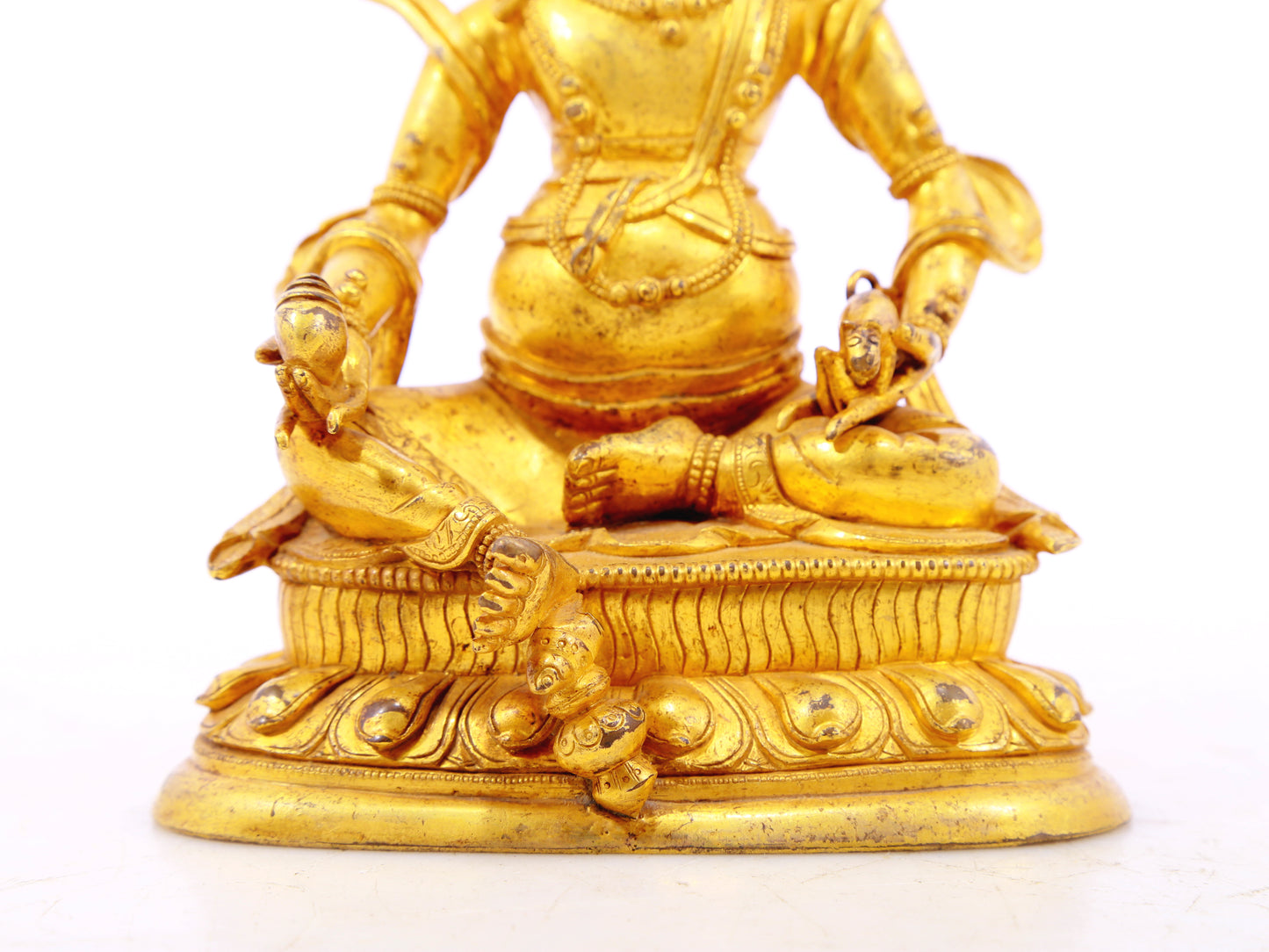 A serene gilt bronze statue of the God of Wealth