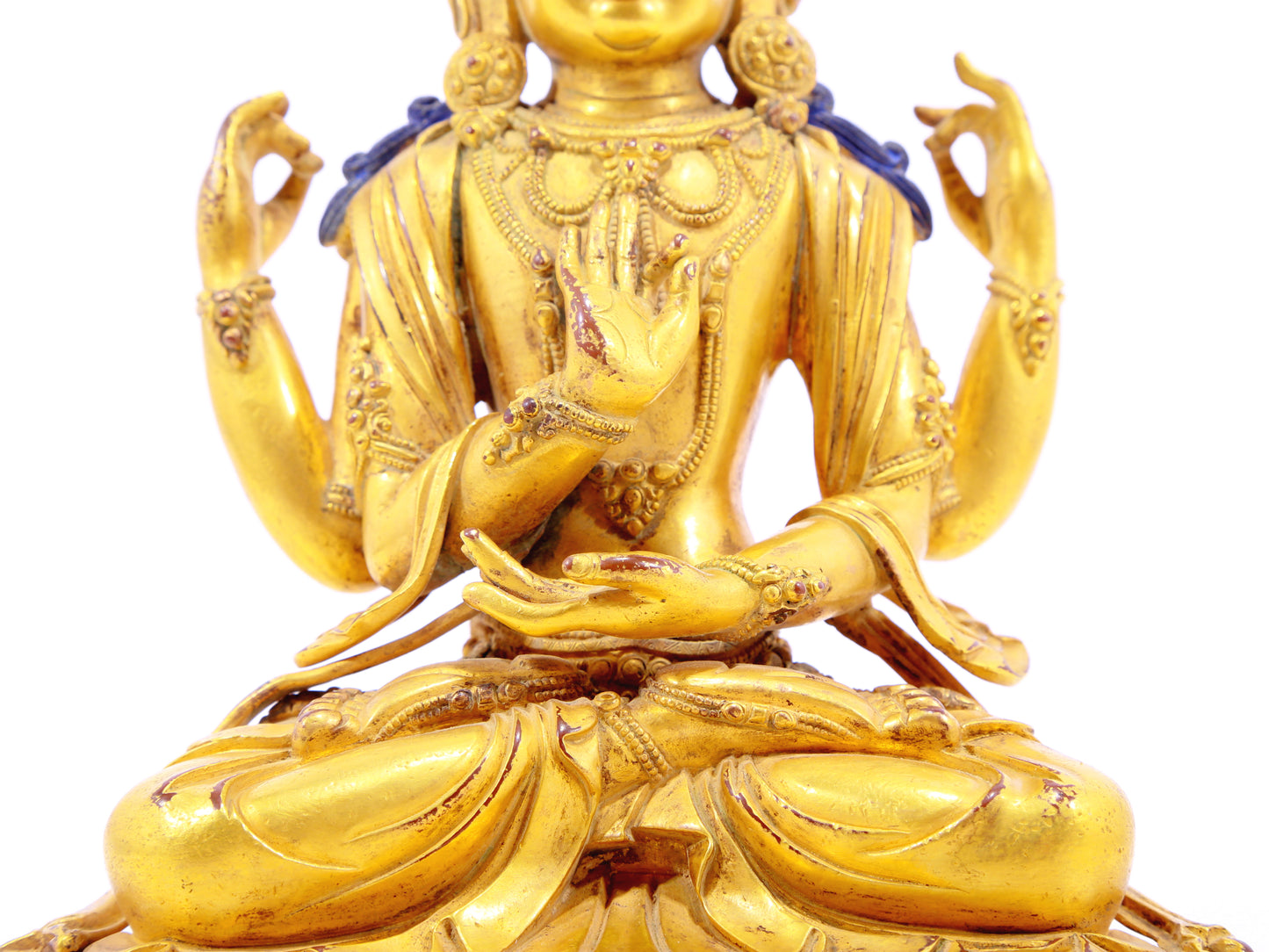 A solemn gilt bronze four-armed Guanyin statue