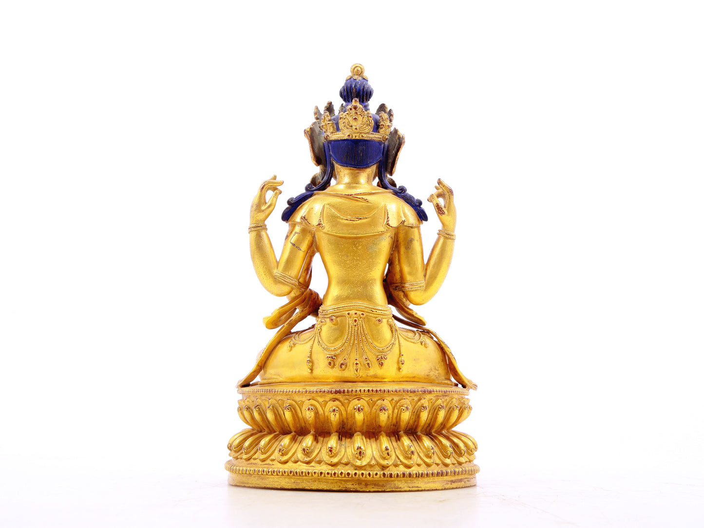 A solemn gilt bronze four-armed Guanyin statue