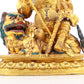 A solemn gilt bronze statue of the Heavenly King inlaid with precious stones