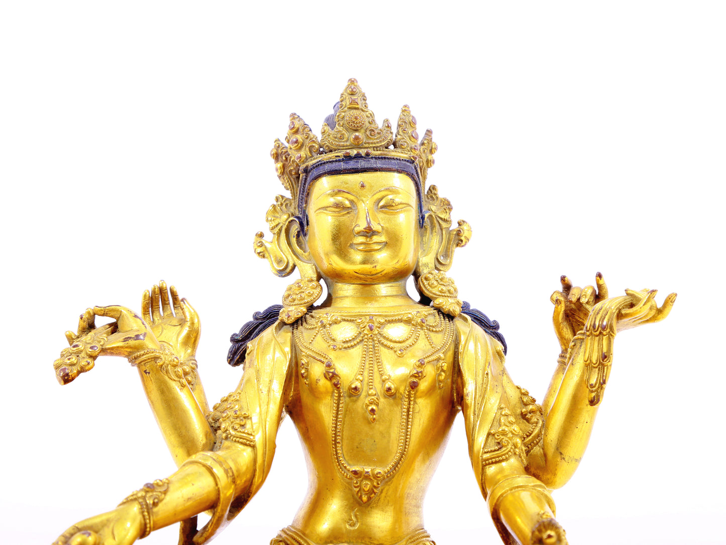 A solemn gilt bronze six-armed Guanyin statue