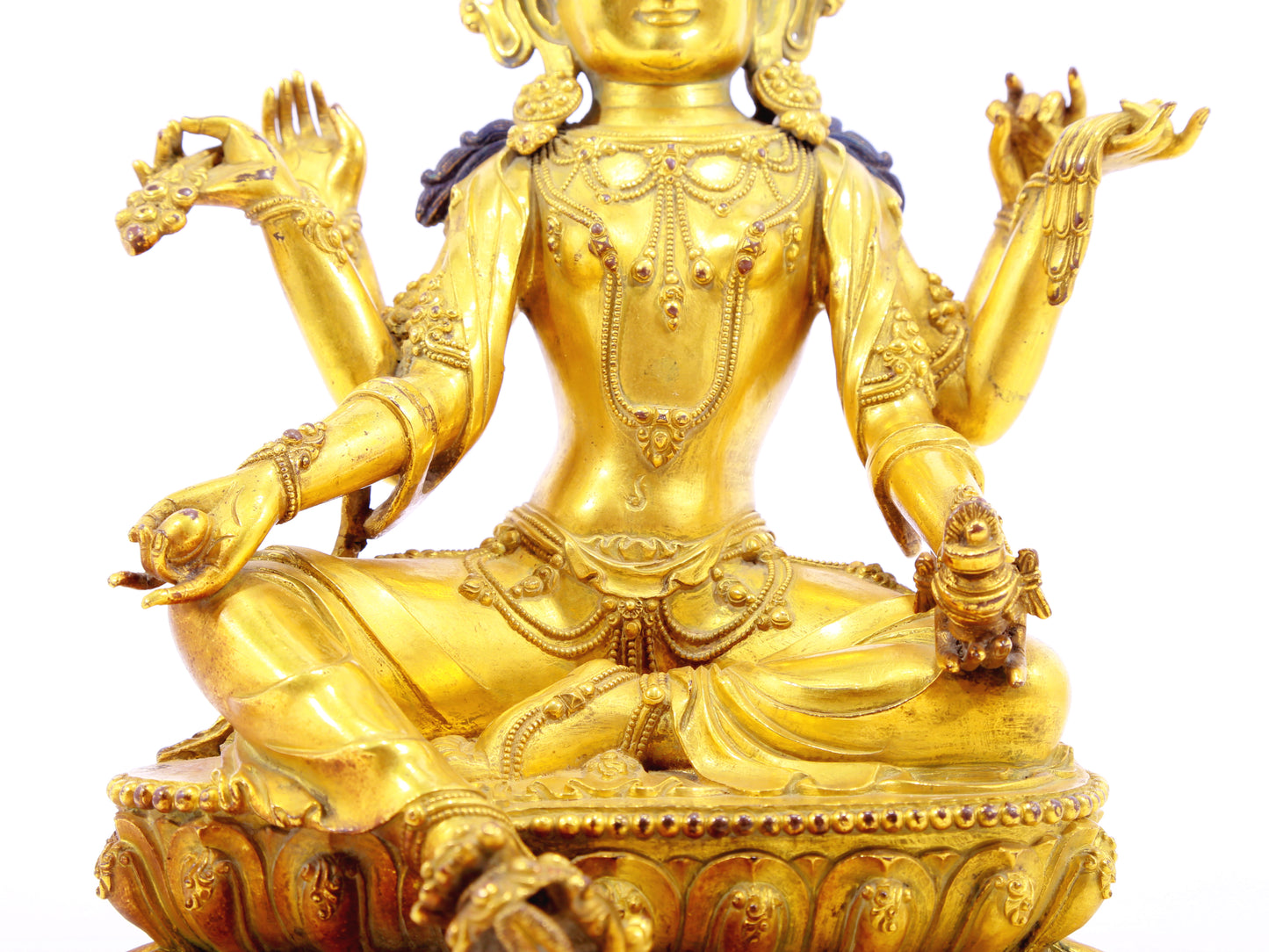 A solemn gilt bronze six-armed Guanyin statue