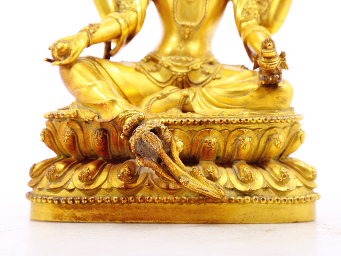 A solemn gilt bronze six-armed Guanyin statue