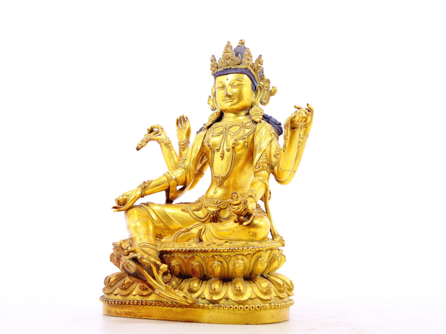 A solemn gilt bronze six-armed Guanyin statue