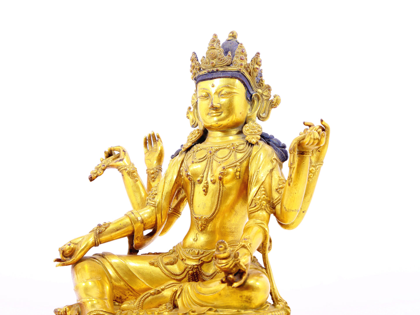 A solemn gilt bronze six-armed Guanyin statue