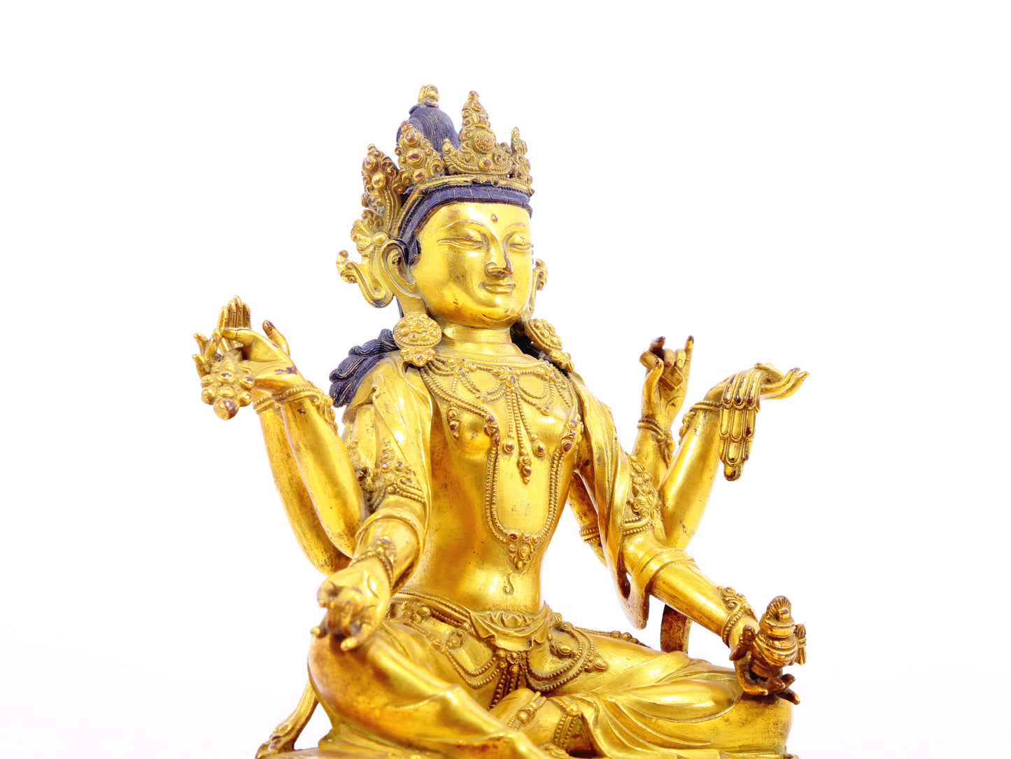 A solemn gilt bronze six-armed Guanyin statue