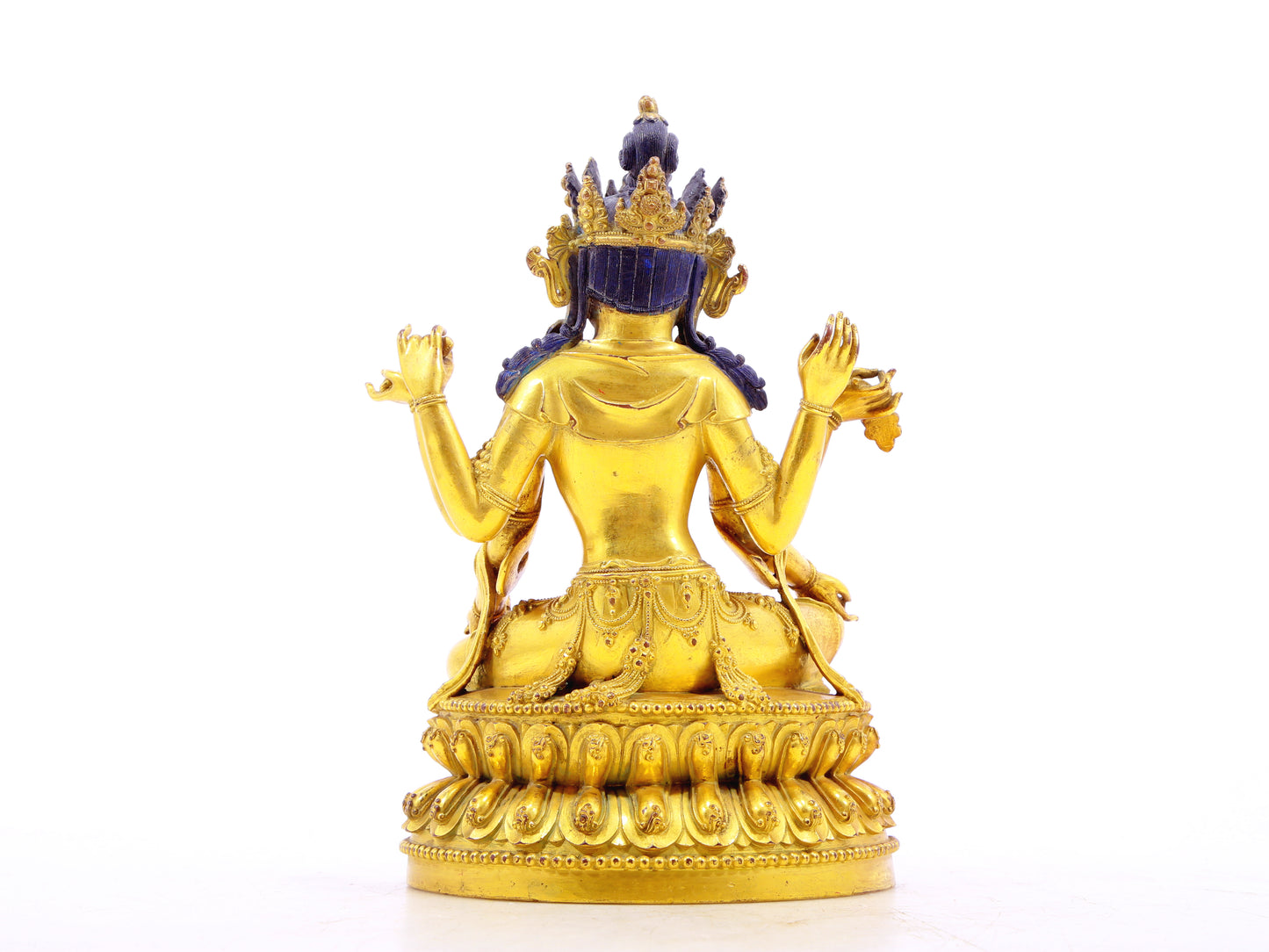 A solemn gilt bronze six-armed Guanyin statue