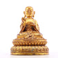 A solemn gilt bronze statue of the guru