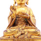 A solemn gilt bronze statue of the guru