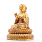 A solemn gilt bronze statue of the guru