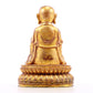 A solemn gilt bronze statue of the guru