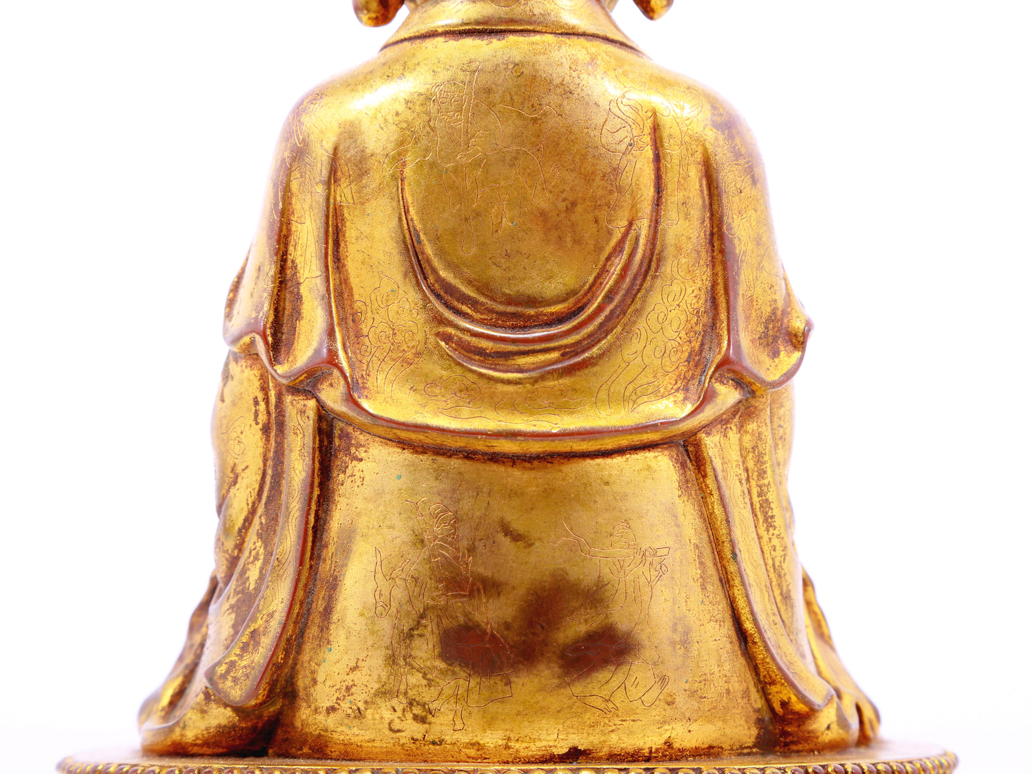 A solemn gilt bronze statue of the guru