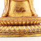 A solemn gilt bronze statue of the guru