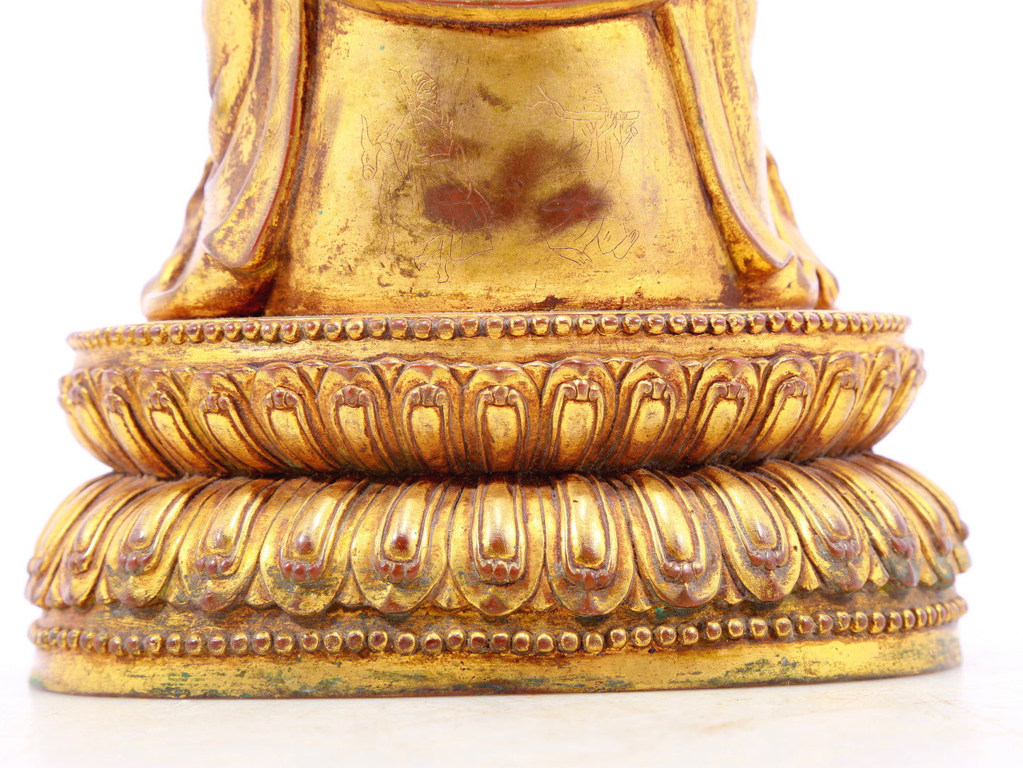 A solemn gilt bronze statue of the guru