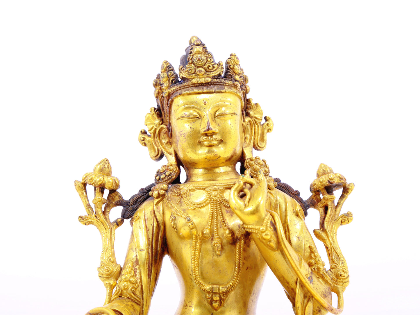 A solemn gilt bronze statue of Tara