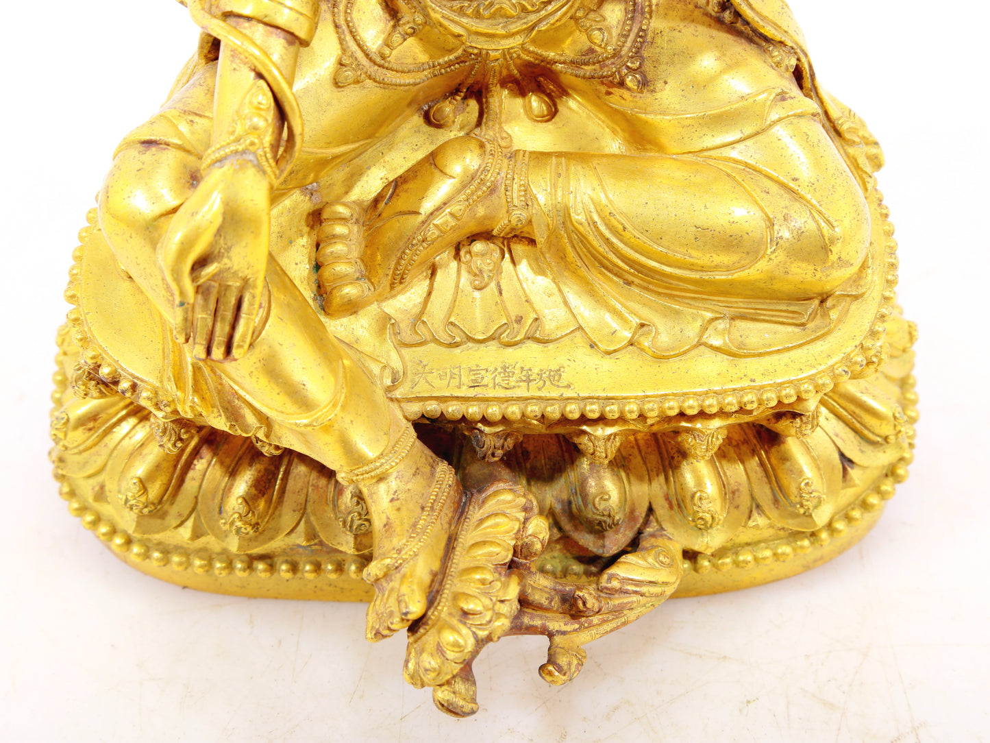 A solemn gilt bronze statue of Tara