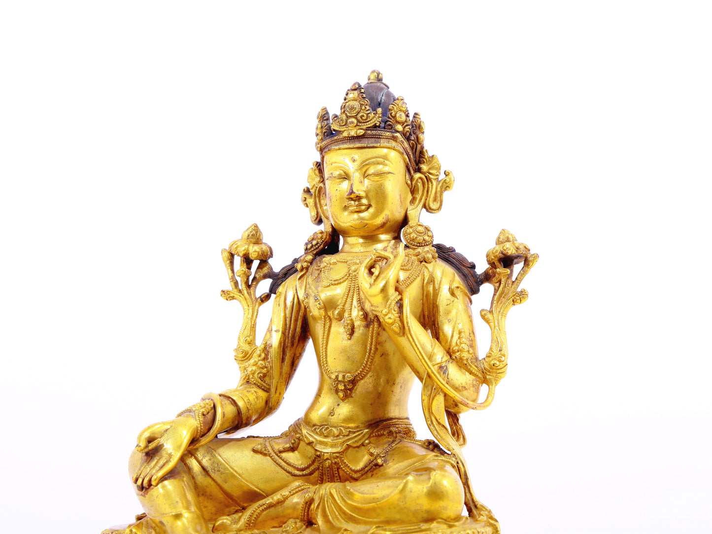 A solemn gilt bronze statue of Tara