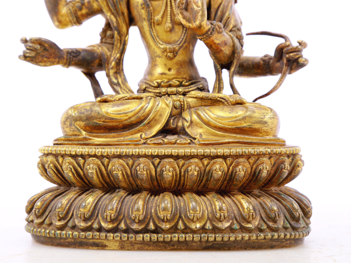 A serene gilt bronze statue of Manjusri with four arms